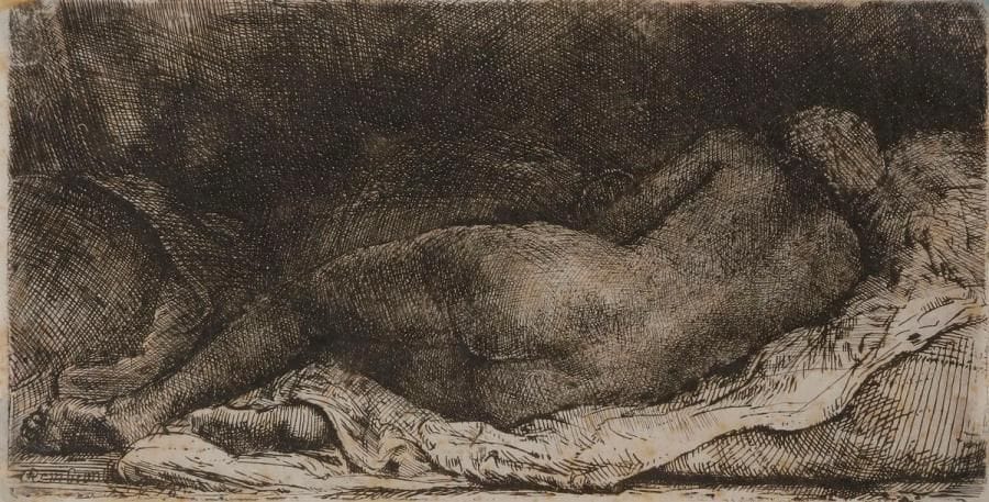Rembrandt Harmensz. van Rijn (1606-1669)
Négresse couchée. 1658. Eau-forte, pointe sèche et burin. 160 x 83. Bartsch 205. Très belle épreuve sur papier exotique pelure, rognée sur le coup de planche, richement encrée, du 3e état (sur 5 selon Nowell-Usticke), avec reprises prononcées sur les contours de la figure et nombreuses tailles additionnelles, le cuivre légèrement usé par places. Petites rousseurs claires éparses. Restes de papier collé dans les angles au verso, partiellement visibles au recto. Tirage Basan.