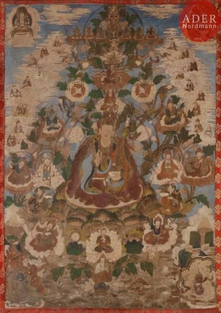 TIBET - XIXe siècle
Tangka, détrempe sur toile. Padmasambhava au centre assis sur le lotus, le trident, dit le Khatvanga trishula, reposant entre son bras et son épaule gauche, tenant le kapala de la main gauche, entouré de lamas, bouddhas et divinités en furie dans les nuages et de lotus en fleur. (Pliures, usures).
Dim. : 76 x 56 cm. Encadré sous verre. 