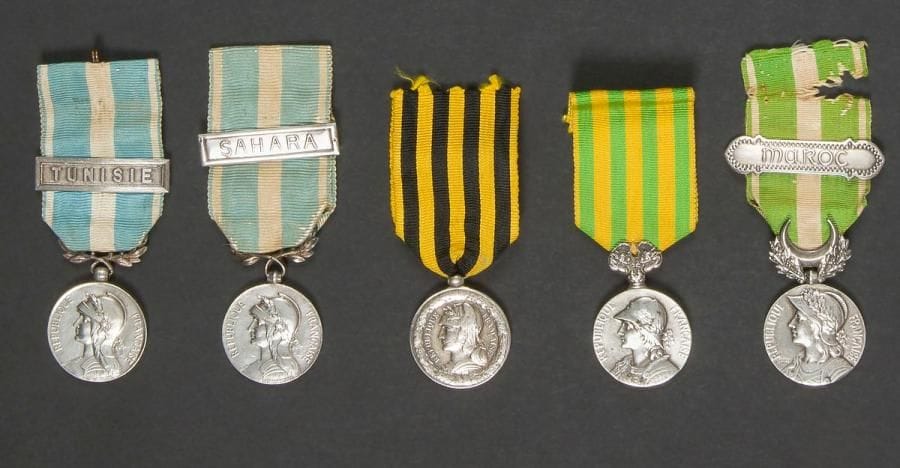 FRANCE 
Cinq médailles : 
- Médaille du Dahomey. Argent. Ruban au modèle postérieur. 
- Médaille du Maroc. Argent. Ruban à agrafe « MAROC ». 
- Médaille de Chine (1901). Argent. Ruban postérieur. (Manque au trophée surmontant la médaille)
- Deux médailles coloniales. Argent. Rubans à agrafes « SAHARA » pour une et « TUNISIE » pour l’autre. 
Poids brut total : 98 g
T.B. 