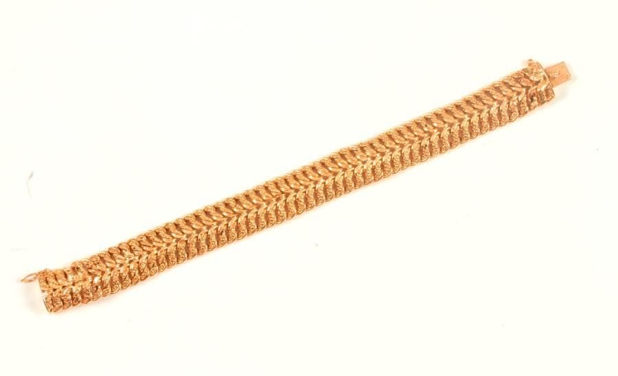 Bracelet en or 18K (750 ‰), articulé de maillons enchevêtrés. Longueur : 18,2 cm environ. 
Poids : 20,9 g