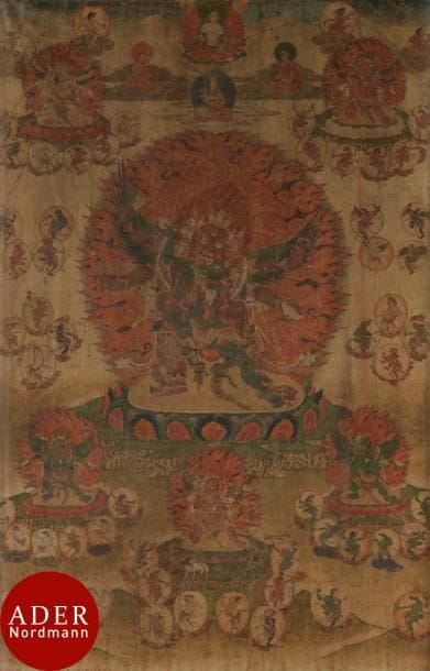 TIBET - XVIIIe siècle
Tangka, détrempe sur toile. Déités du Bar-do, Hayagriva en furie à trois têtes et six bras les ailes ouvertes, tenant le damaru, le Khatvanga, le vajra, le ghanta, le kapala, debout en yab-yum avec sa satki sur le lotus au centre, devant une mandorle enflammée, entourés de divinités en furie, sorcières et lama, surmonté en partie supérieure de bouddha. (Pliures, usures, taches).
Dim. : 70 x 48 cm ; encadré sous verre.