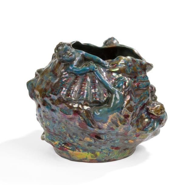DOMINIQUE ZUMBO (1854-1939)

Flots mouvementés et animés de naïades, putti et coquillages
Exceptionnel vase au décor symboliste en haut-relief.
Épreuve en céramique émaillée aux riches effets métallisés et irisés.
Circa 1900.
Signé et situé Dominique ZUMBO Arènes Fréjus (Var) et porte le tampon en creux de l’atelier sous la base.
32 x 38 x 40 cm

Provenance :
Collection particulière, Munich.