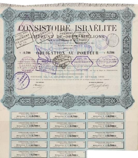EMPRUNT CONSISTORIAL - Obligation au porteur dans le cadre de l'emprunt de deux millions contracté par le Consistoire pour faire bâtir deux synagogues par délibération des 17 février et 13 décembre 1864. Page in folio avec une partie des coupons encore attachés (cachets d'encaissement jusqu'en 1904, mais les coupons jusqu'en 1877 non encaissés). Une de ces deux synagogues est la synagogue de la Victoire, la principale synagogue de Paris, dont la construction débuta en 1867, qui fut inaugurée en 1874 et ouverte au culte public en 1875.