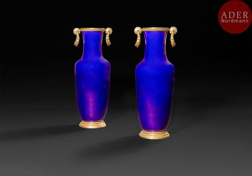 Paire de vases en balustre en porcelaine bleue à monture de bronze doré à guirlandes et rosaces ; la porcelaine inscrite Sèvres.
Style Louis XVI.
H : 36,5 cm