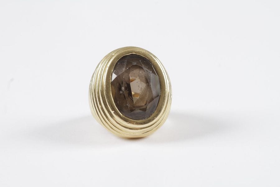 Bague d'homme en or jaune 18K (750) godronné, ornée d'un quartz fumé de forme ovale. Poids brut: 48,1 g