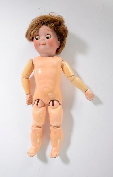 Poupée Googlie, tête porcelaine marquée en 221, yeux bleus (bloqués), bouche femrée, perruque châtain, corps articulé en bois et composition à 4 boules.

Hauteur : 31 cm