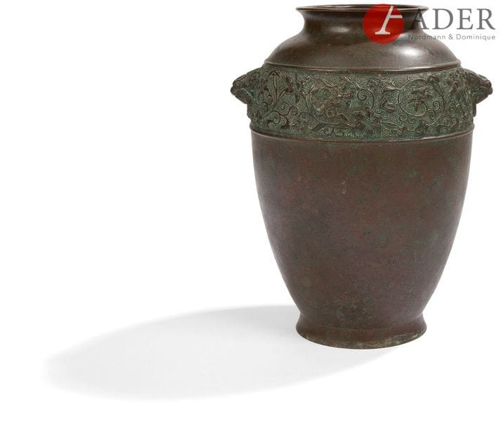 JAPON - Fin XIXe siècle
Vase en bronze à patine brune à décor à l’épaulement de frise de rinceaux de lotus.
H. : 23 cm