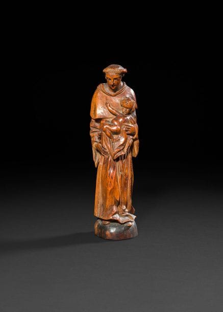 Saint Antoine de Padoue en buis sculpté en ronde-bosse. XXe siècle Hauteur : 27 cm (petits manques, restauration au nez)