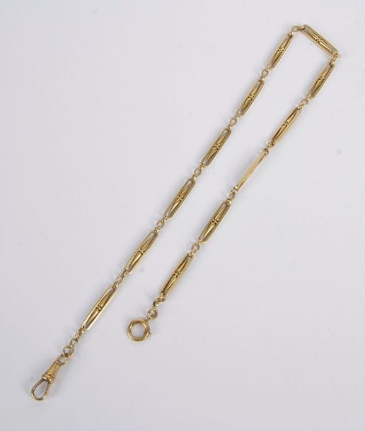 Chaîne de montre giletière en or 18K (750), on joint un bris d'or 18K. Poids: 25,9 g