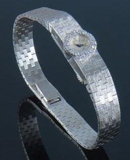 Montre-bracelet de dame ronde en or gris, le cadran serti de brillants et le tour de poignet en or gris brossé. Audemard, Piguet & co . Poids brut : 27 g. (Ecrin).