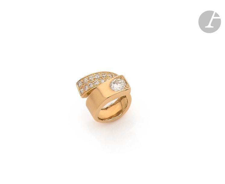 JEAN VENDOME (attribuée à)
Bague Ruban en or 18K (750), d’un côté ornée d’un diamant rond pesant 1,19 ct, pavée de diamants ronds de l’autre. Non signée. 
Tour de doigt : 46. 
Poids brut : 9,9 g (traces de mise à taille)