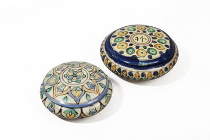 Deux bonbonnières en faïence polychromes,...
