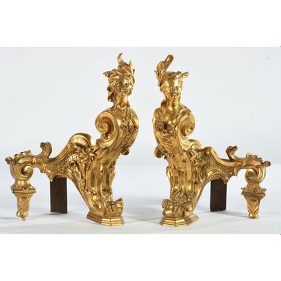 PAIR OF REGIONAL CHENETS in gilded bronze...