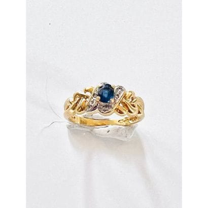 Braided ring with a sapphire and small diamonds....