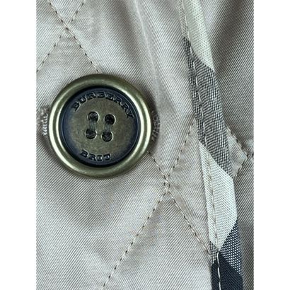 BURBERRY BRIT. Beige quilted jacket in polyester....