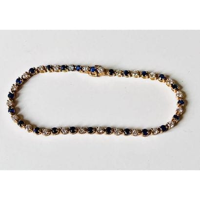 BRACELET tennis in yellow gold 750°/°° decorated...
