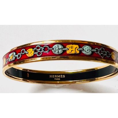 HERMES. BRACELET rigide en métal doré émaillé...