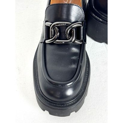 TOD'S. Black leather loafers adorned with...