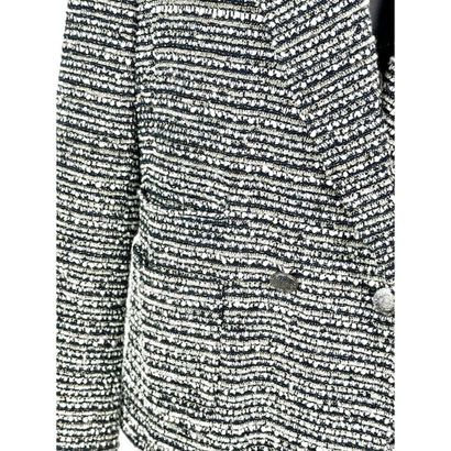 CHANEL. Black, pearl-grey and gold tweed...