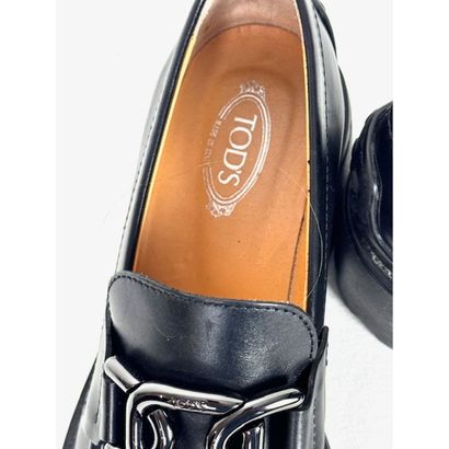 TOD'S. Black leather loafers adorned with...