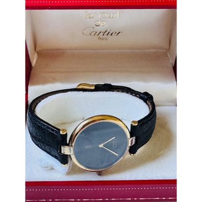 CARTIER. Watch in vermeil. Round case. Black...
