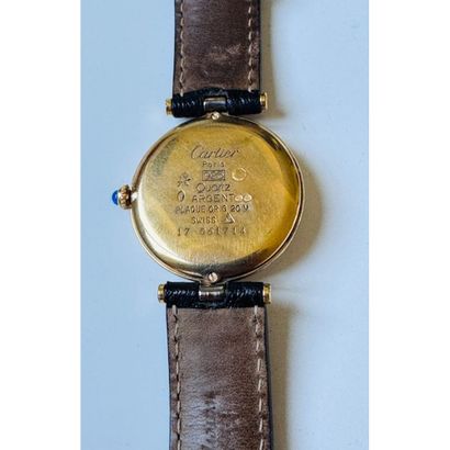 CARTIER. Watch in vermeil. Round case. Black...