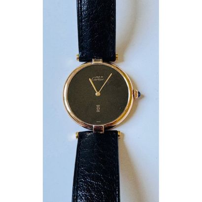 CARTIER. Watch in vermeil. Round case. Black...