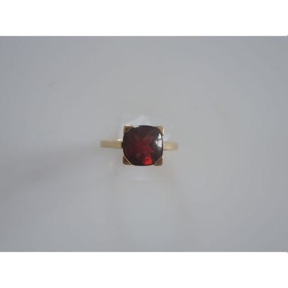 BAGUE en or jaune ornée d’un grenat cabochon...