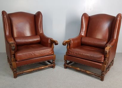 THREE brown leather wing chairs with wooden...