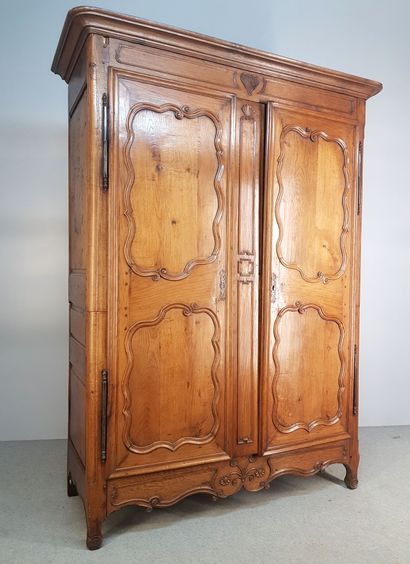 OAK CABINET opening with two moulded doors,...