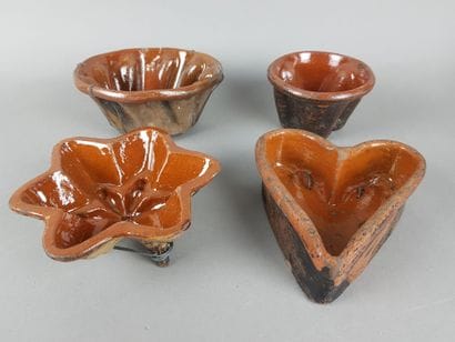 FOUR antique brown glazed terracotta cake...