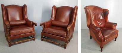 THREE brown leather wing chairs with wooden...