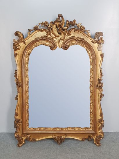 A Louis XV style stucco and gilded wood mirror...