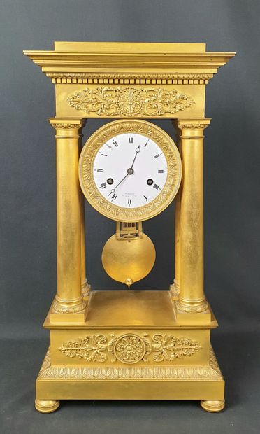 A gilt bronze portico clock decorated with...