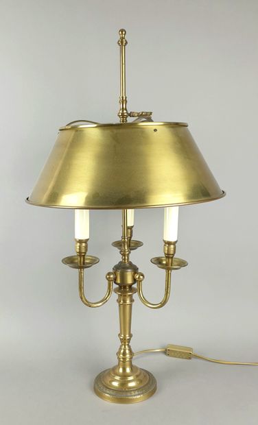 A brass three-armed floor lamp with a gilded...