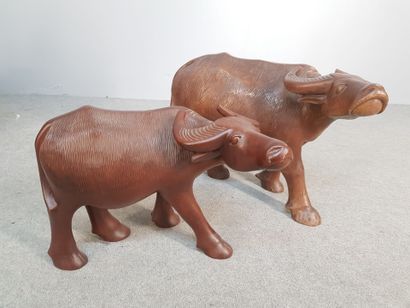 TWO carved wooden SUBJECTS representing buffalos....