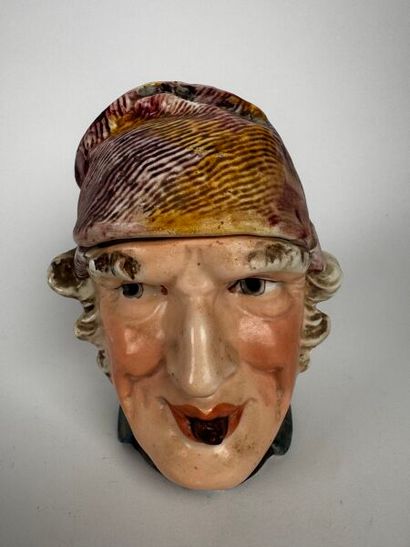 Tobacco jar. The head of an aging man with...