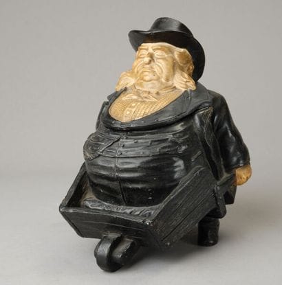 A large, whimsical tobacco jar depicting...