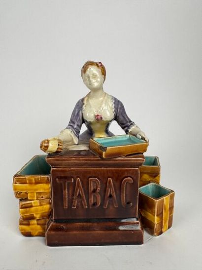 A composite tobacco jar depicting a smiling...