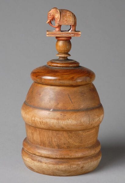 Urn-shaped tobacco jar with a body adorned...