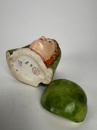 Tobacco jar. A small head of a very young...