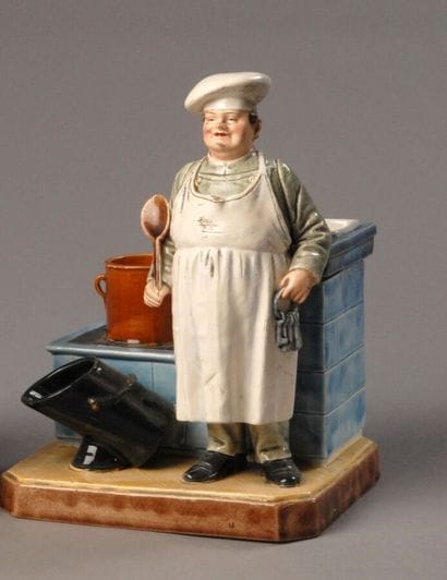 Tobacco jar
A cook wearing a chef's hat,...
