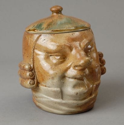 Tobacco jar. Depicts the head of a chubby,...