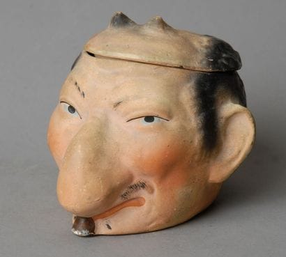 Tobacco Jar
A small caricatured head of a...
