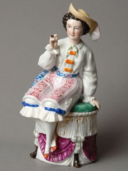 Tobacco jar. A figure of a woman of easy...