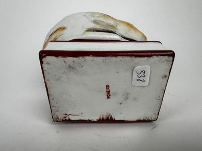 A large tobacco jar made of glossy white...