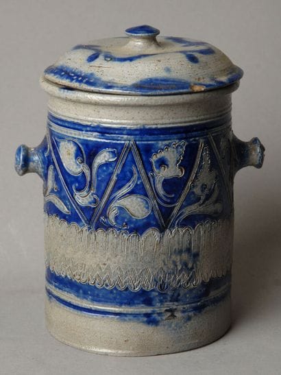 Tall, urn-shaped tobacco jar made of gray...