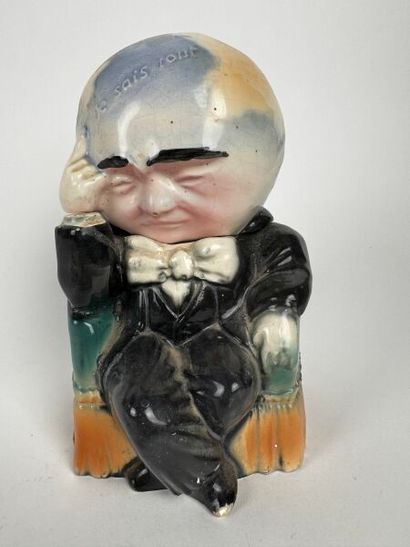 A whimsical tobacco jar depicting a grotesque...
