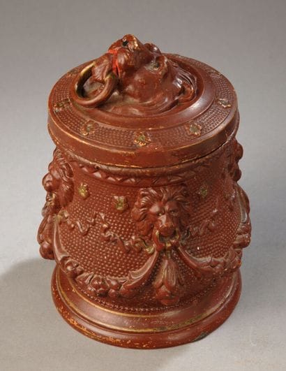 A pot shaped like an antique brown urn, decorated...