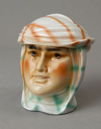 A small tobacco jar depicting the head of...